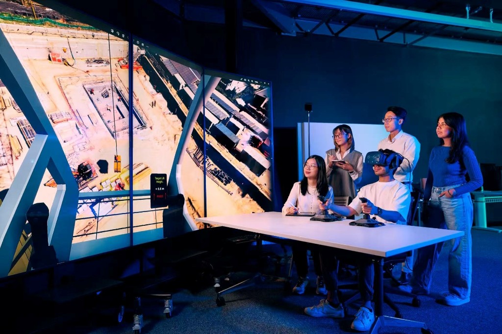 Researchers using VR and the immersive 4K screen wall for large-scale construction data visualisation