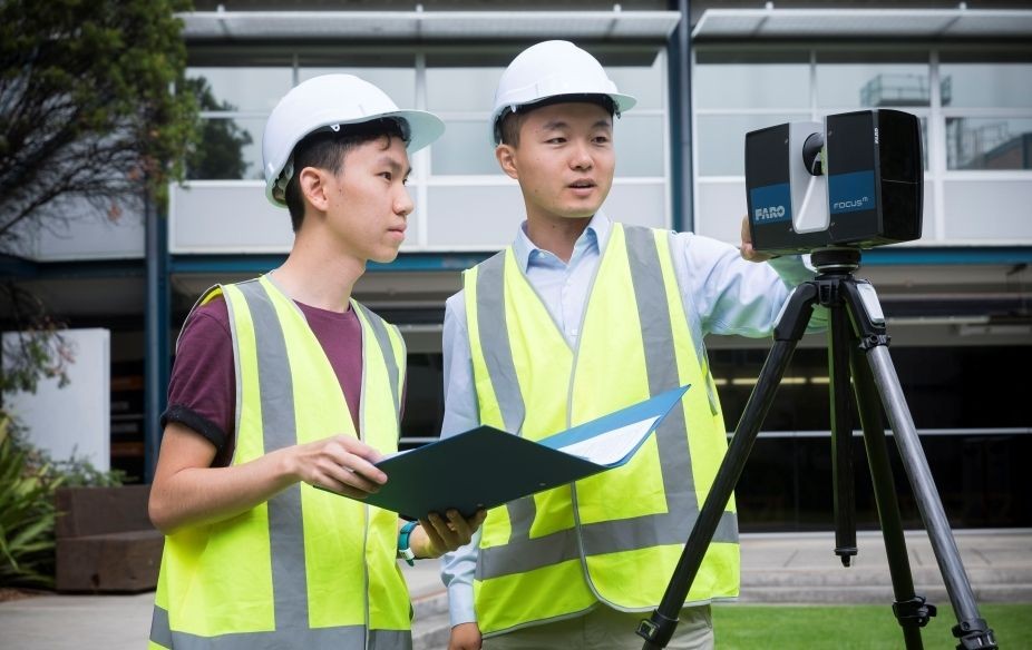 Researchers operating a terrestrial FARO 3D laser scanner on the Monash University campus